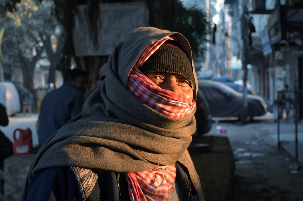 New Delhi, Dec 20 (ANI): A man covering his face with clothes spotted on a cold winter morning, in New Delhi on Monday. (ANI Photo)