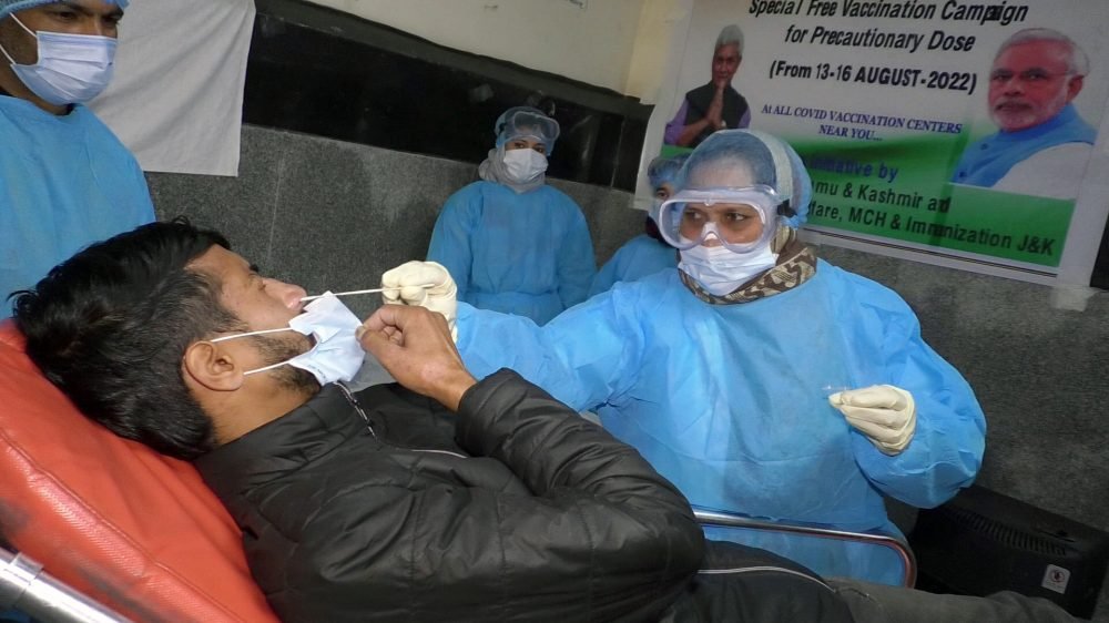 Poonch, Dec 27 (ANI): A healthcare worker collects a nasal swab sample of a man for the COVID-19 testing during the mock drill conducted to ensure Covid management preparedness in view of the rising cases of Coronavirus in some countries including China, at Raja Sukhdev Singh District Hospital, in Poonch on Tuesday. (ANI Photo)