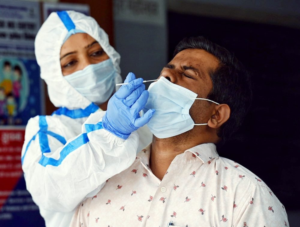 New Delhi, Apr 13 (ANI): A health worker collects a swab sample for the Covid-19 test, at Daryaganj Dispensary amid a surge in cases, in New Delhi on Thursday. (ANI Photo)