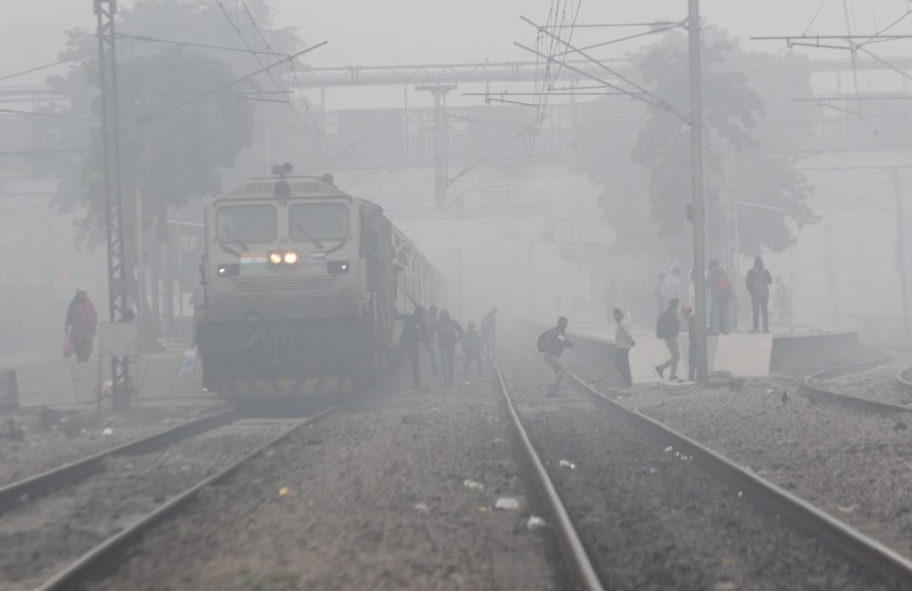 New Delhi, Dec 27 (ANI): Passengers get off of a train at a station amid low visibility on a foggy winter morning, in New Delhi on Wednesday. (ANI Photo/Amit Sharma)