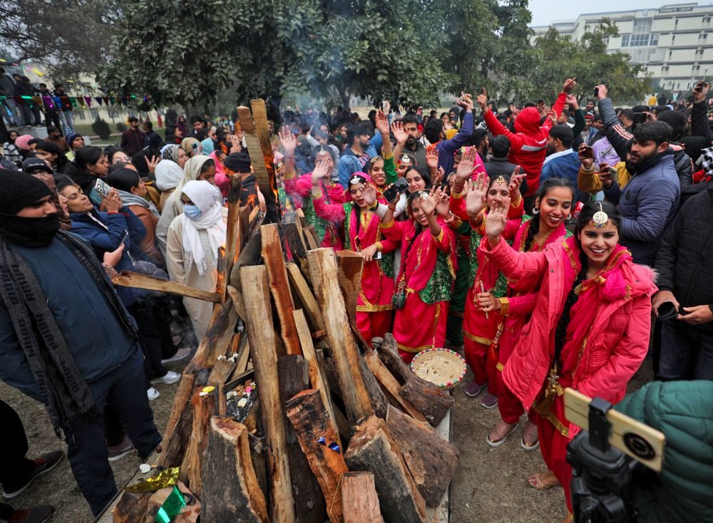 Jammu, Jan 12 (ANI): Jammu University students dressed in traditonal attires participate during Lohri festival celebration at Jammu University, in Jammu on Friday. (ANI Photo)